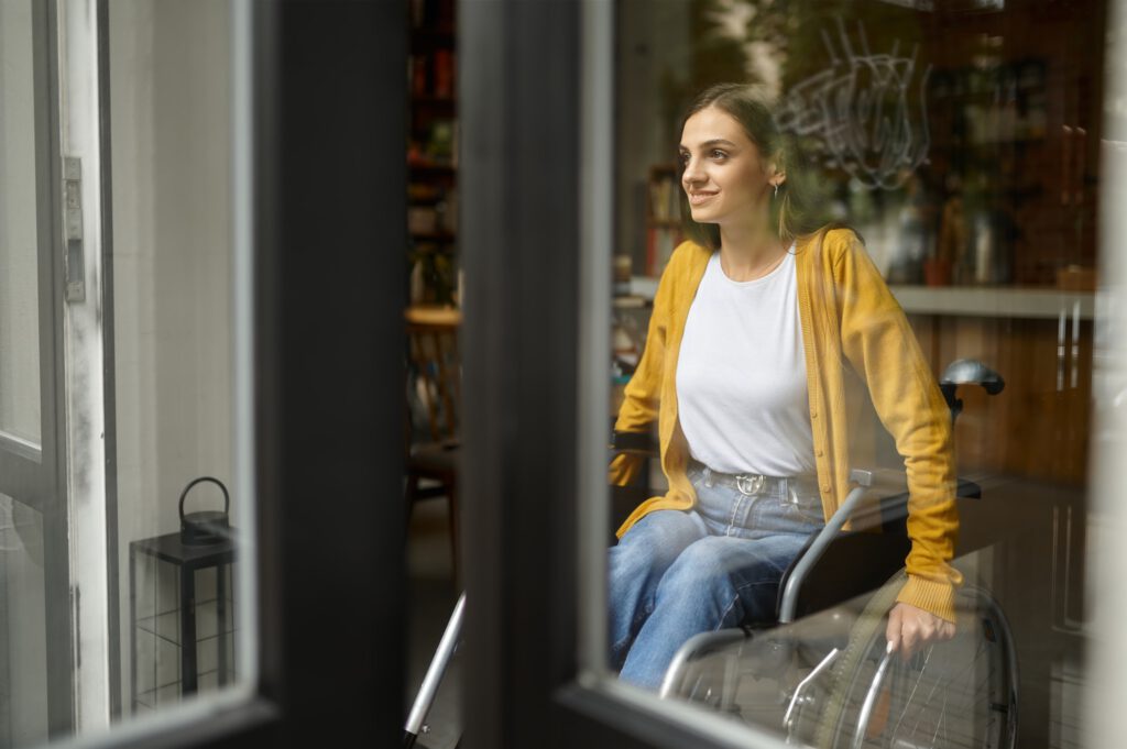 Disabled female student in wheelchair at window